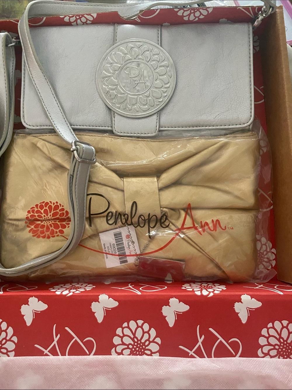 Gold Clutch and Silver crossbody purse by “Penelope Ann”.